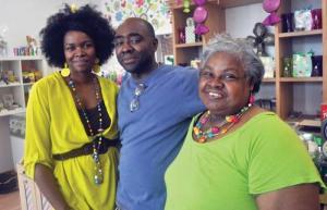 A Sweet Place: The owners of the new Fields Corner store A Sweet Life won an online contest and a visit from ‘Cash Mob Dorchester’ on Monday. From left, Beverly Hilaire, Edwin Hilaire, and Mae Riggs, Beverly’s mom. 	Photo by Bill Forry